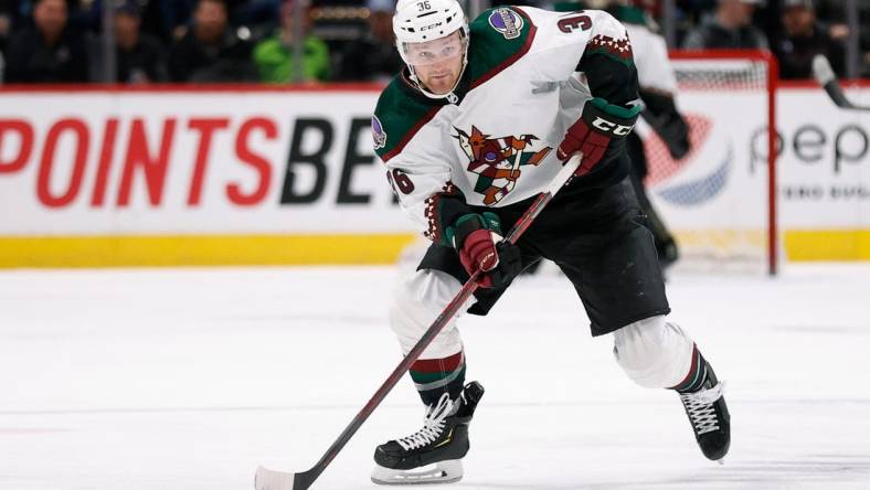 Feb 1, 2022; Denver, Colorado, USA; Arizona Coyotes right wing Christian Fischer (36) controls the puck in the third period against the Colorado Avalanche at Ball Arena. Mandatory Credit: Isaiah J. Downing-USA TODAY Sports