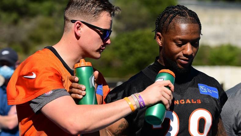 Feb 11, 2022; Los Angeles, CA, USA; Cincinnati Bengals quarterback Joe Burrow (9) and running back Joe Mixon (28) do a mock interview following media availabilty for Super Bowl LVI at Drake Stadium. Mandatory Credit: Gary A. Vasquez-USA TODAY Sports