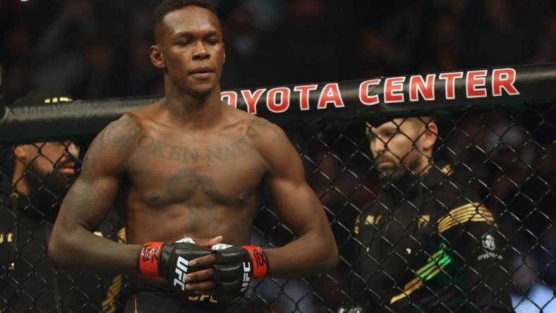 Feb 12, 2022; Houston, Texas, UNITED STATES; Israel Adesanya (red gloves) before the fight against Robert Whittaker (blue gloves) during UFC 271 at Toyota Center. Mandatory Credit: Troy Taormina-USA TODAY Sports