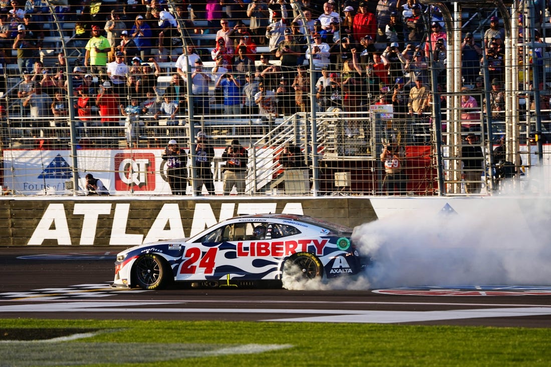 Mar 20, 2022; Hampton, Georgia, USA; NASCAR Cup Series driver William Byron (24) performs a burnout as he celebrates winning the Folds of Honor QuikTrip 500 at Atlanta Motor Speedway. Mandatory Credit: John David Mercer-USA TODAY Sports