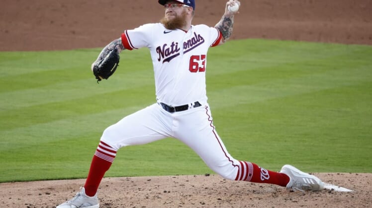 Mar 21, 2022; West Palm Beach, Florida, USA; Washington Nationals pitcher Sean Doolittle (63) pitches against the St. Louis Cardinals in the third inning during spring training at The Ballpark of the Palm Beaches. Mandatory Credit: Rhona Wise-USA TODAY Sports