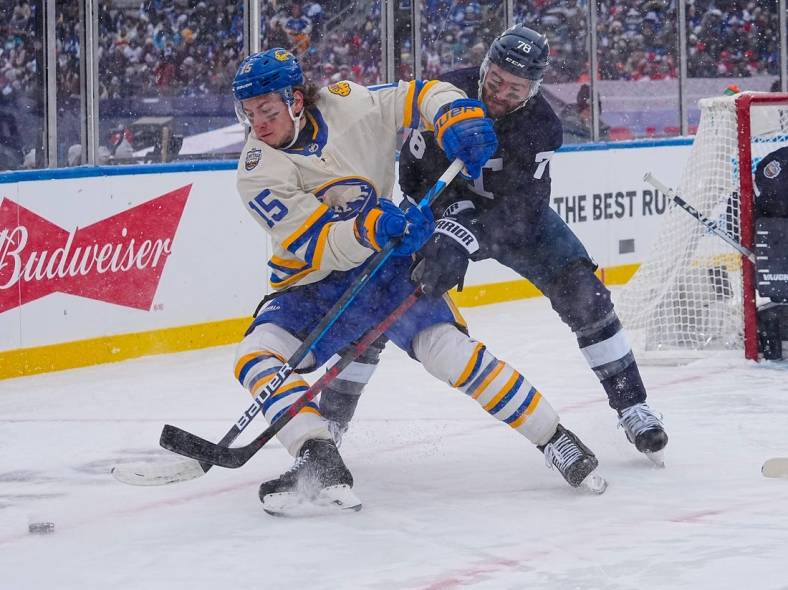 Mar 13, 2022; Hamilton, Ontario, CAN; Buffalo Sabres forward John Hayden (15) battles with Toronto Maple Leafs defenseman Tj Brodie (78) for the puck in the 2022 Heritage Classic ice hockey game at Tim Hortons Field. Mandatory Credit: John E. Sokolowski-USA TODAY Sports