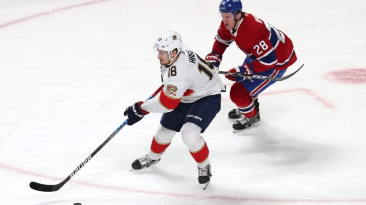 Mar 24, 2022; Montreal, Quebec, CAN; Florida Panthers defenseman Robert Hagg (18) plays the puck against Montreal Canadiens left wing Christian Dvorak (28) during the second period at Bell Centre. Mandatory Credit: Jean-Yves Ahern-USA TODAY Sports