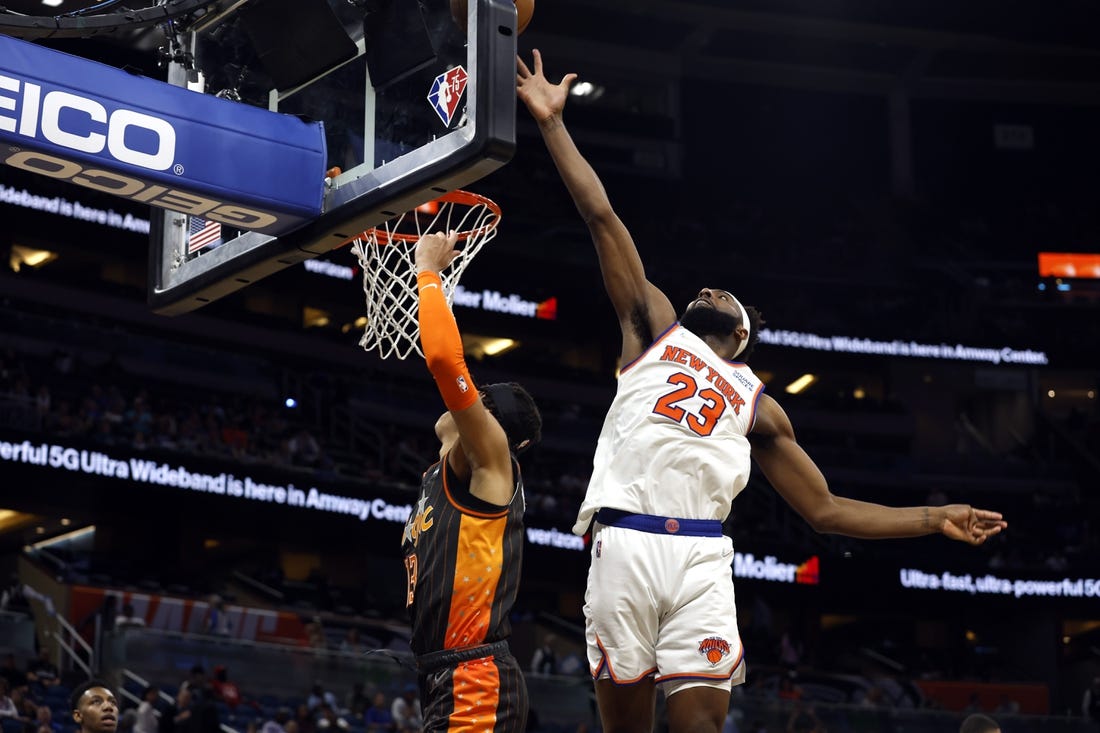 Apr 3, 2022; Orlando, Florida, USA; New York Knicks center Mitchell Robinson (23) defends Orlando Magic guard R.J. Hampton (13) shot during the second half at Amway Center. Mandatory Credit: Kim Klement-USA TODAY Sports