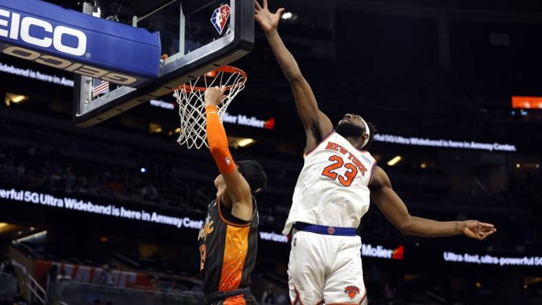 Apr 3, 2022; Orlando, Florida, USA; New York Knicks center Mitchell Robinson (23) defends Orlando Magic guard R.J. Hampton (13) shot during the second half at Amway Center. Mandatory Credit: Kim Klement-USA TODAY Sports