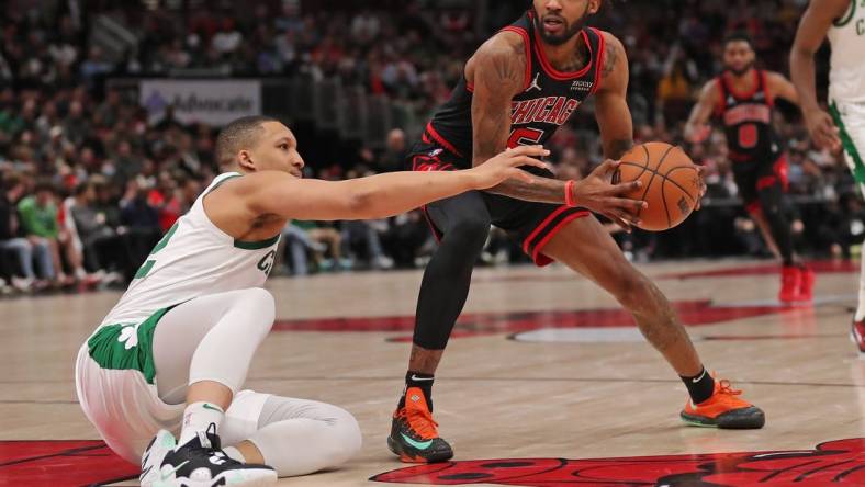 Apr 6, 2022; Chicago, Illinois, USA; Chicago Bulls forward Derrick Jones Jr. (5) being defended by Boston Celtics forward Grant Williams (12) during the second half at the United Center. Mandatory Credit: Dennis Wierzbicki-USA TODAY Sports