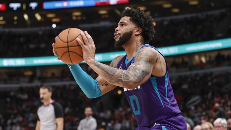 Apr 8, 2022; Chicago, Illinois, USA; Charlotte Hornets forward Miles Bridges (0) shoots against the Chicago Bulls during the second half at United Center. Mandatory Credit: Kamil Krzaczynski-USA TODAY Sports