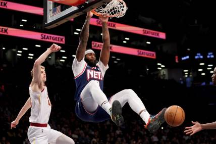 Apr 8, 2022; Brooklyn, New York, USA; Brooklyn Nets center Andre Drummond (0) dunks against Cleveland Cavaliers forward Lauri Markkanen (24) during the fourth quarter at Barclays Center. Mandatory Credit: Brad Penner-USA TODAY Sports