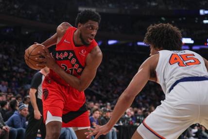Apr 10, 2022; New York, New York, USA; Toronto Raptors forward Thaddeus Young (21) shields the ball from New York Knicks forward Jericho Sims (45) during the first half at Madison Square Garden. Mandatory Credit: Vincent Carchietta-USA TODAY Sports