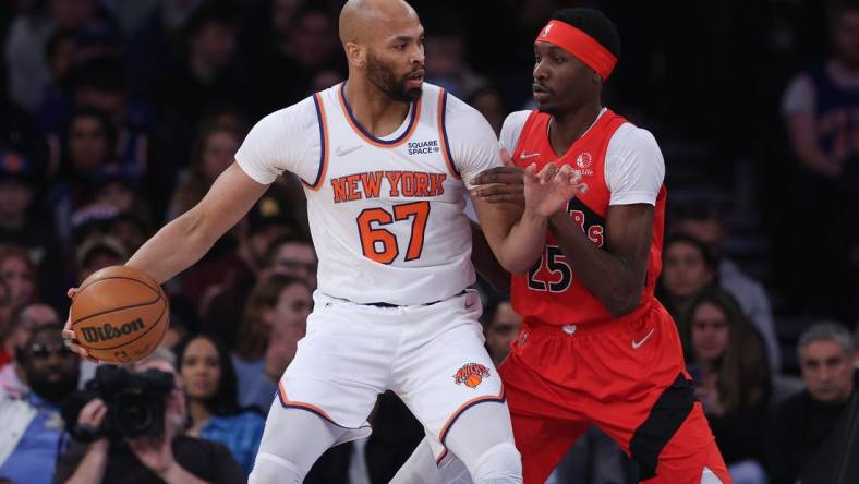 Apr 10, 2022; New York, New York, USA; New York Knicks center Taj Gibson (67) dribbles against Toronto Raptors forward Chris Boucher (25) during the first half at Madison Square Garden. Mandatory Credit: Vincent Carchietta-USA TODAY Sports