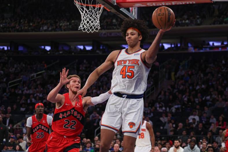 Apr 10, 2022; New York, New York, USA; New York Knicks forward Jericho Sims (45) passes the ball as Toronto Raptors guard Malachi Flynn (22) defends during the second half at Madison Square Garden. Mandatory Credit: Vincent Carchietta-USA TODAY Sports
