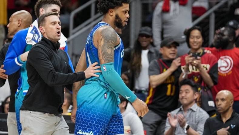 Apr 13, 2022; Atlanta, Georgia, USA; Charlotte Hornets forward Miles Bridges (0) is restrained after being called for a technical foul and being ejected from the game against the Atlanta Hawks during the second half at State Farm Arena. Mandatory Credit: Dale Zanine-USA TODAY Sports