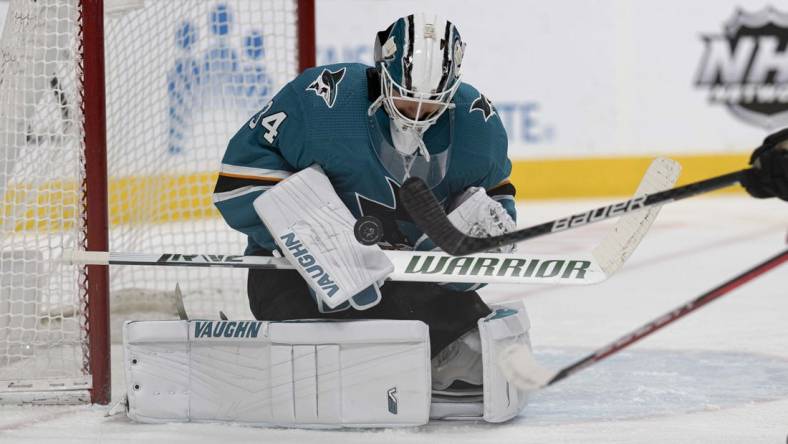 Apr 19, 2022; San Jose, California, USA;  San Jose Sharks goaltender Kaapo Kahkonen (34) defends the goal during the first period against the Columbus Blue Jackets at SAP Center at San Jose. Mandatory Credit: Stan Szeto-USA TODAY Sports