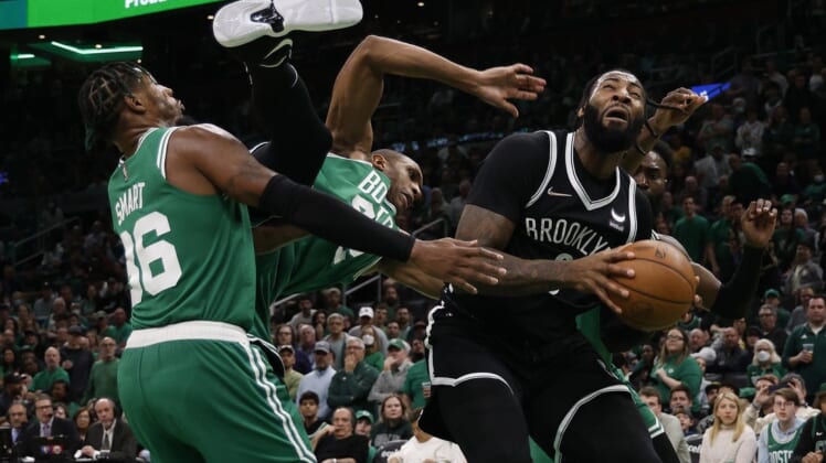 Apr 20, 2022; Boston, Massachusetts, USA; Boston Celtics center Al Horford (42) goes tumbling between guard Marcus Smart (36) and Brooklyn Nets center Andre Drummond (0) during the third quarter of game two of the first round of the 2022 NBA playoffs at TD Garden. Mandatory Credit: Winslow Townson-USA TODAY Sports