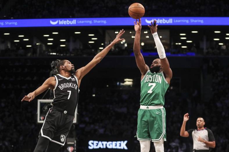 Apr 23, 2022; Brooklyn, New York, USA;  Boston Celtics guard Jaylen Brown (7) takes a three point shot over Brooklyn Nets forward Kevin Durant (7) in the first quarter at Barclays Center. Mandatory Credit: Wendell Cruz-USA TODAY Sports