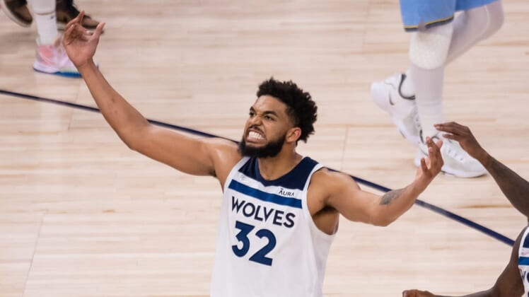 Apr 23, 2022; Minneapolis, Minnesota, USA; Minnesota Timberwolves center Karl-Anthony Towns (32) celebrates against the Memphis Grizzlies in the third quarter during game four of the first round for the 2022 NBA playoffs at Target Center. Mandatory Credit: Brad Rempel-USA TODAY Sports