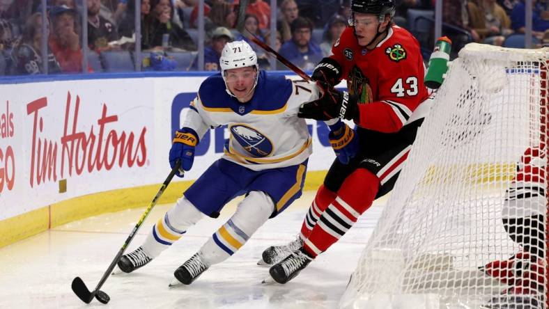 Apr 29, 2022; Buffalo, New York, USA;  Buffalo Sabres left wing Victor Olofsson (71) skates behind the net as Chicago Blackhawks defenseman Alex Vlasic (43) defends during the second period at KeyBank Center. Mandatory Credit: Timothy T. Ludwig-USA TODAY Sports