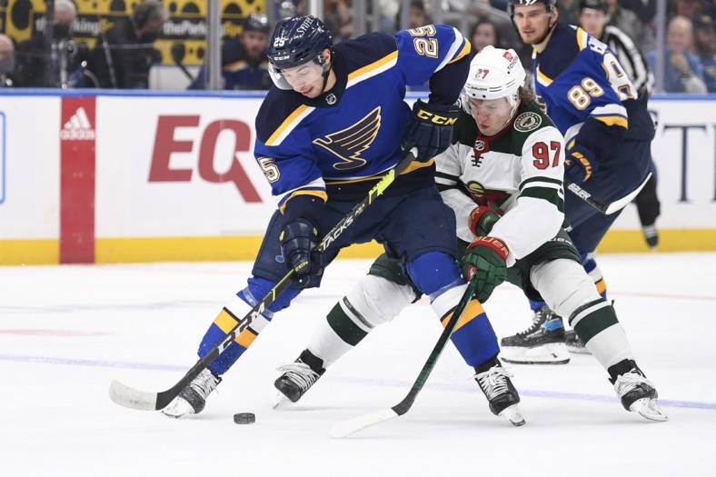 May 8, 2022; St. Louis, Missouri, USA; Minnesota Wild left wing Kirill Kaprizov (97) pressures St. Louis Blues center Jordan Kyrou (25) during the first period in game four of the first round of the 2022 Stanley Cup Playoffs at Enterprise Center. Mandatory Credit: Jeff Le-USA TODAY Sports