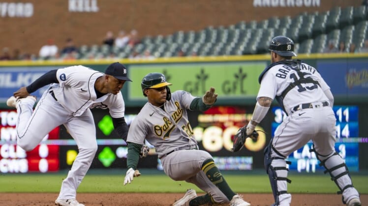 May 11, 2022; Detroit, Michigan, USA; Detroit Tigers second baseman Jonathan Schoop (7) tags out Oakland Athletics center fielder Cristian Pache (20) before he gets back to first base during the second inning at Comerica Park. Mandatory Credit: Raj Mehta-USA TODAY Sports