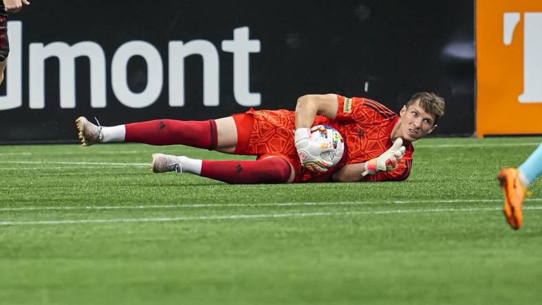 May 15, 2022; Atlanta, Georgia, USA; Atlanta United goalkeeper Bobby Shuttleworth (18) dives on the ball against the New England Revolution during the first half at Mercedes-Benz Stadium. Mandatory Credit: Dale Zanine-USA TODAY Sports