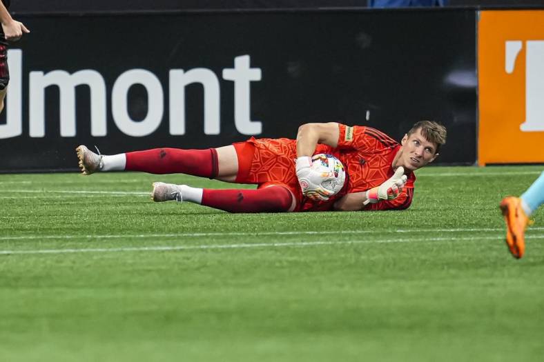 May 15, 2022; Atlanta, Georgia, USA; Atlanta United goalkeeper Bobby Shuttleworth (18) dives on the ball against the New England Revolution during the first half at Mercedes-Benz Stadium. Mandatory Credit: Dale Zanine-USA TODAY Sports