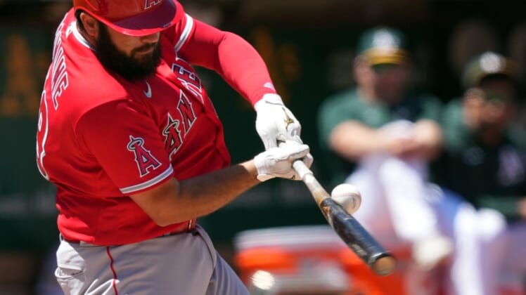 May 14, 2022; Oakland, California, USA; Los Angeles Angels catcher Austin Romine (19) bats against the Oakland Athletics during the fourth inning at RingCentral Coliseum. Mandatory Credit: Darren Yamashita-USA TODAY Sports
