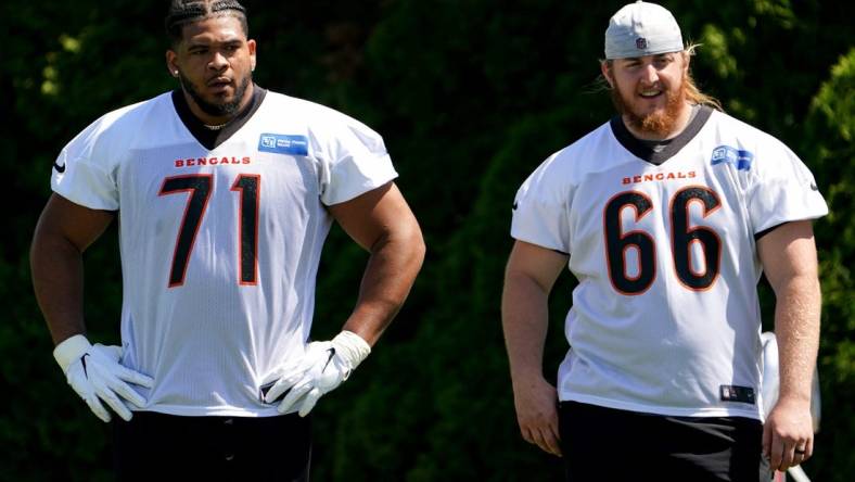 Cincinnati Bengals offensive tackle La'el Collins (71) and offensive guard Alex Cappa (66) wait their turn for a drill during practice, Tuesday, May 17, 2022, at the Paul Brown Stadium practice fields in Cincinnati.

Cincinnati Bengals Practice May 17 0098