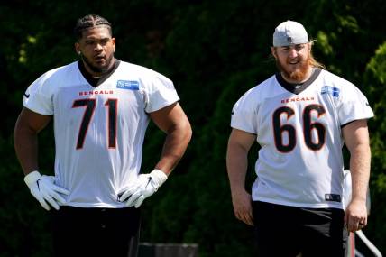 Cincinnati Bengals offensive tackle La'el Collins (71) and offensive guard Alex Cappa (66) wait their turn for a drill during practice, Tuesday, May 17, 2022, at the Paul Brown Stadium practice fields in Cincinnati.

Cincinnati Bengals Practice May 17 0098