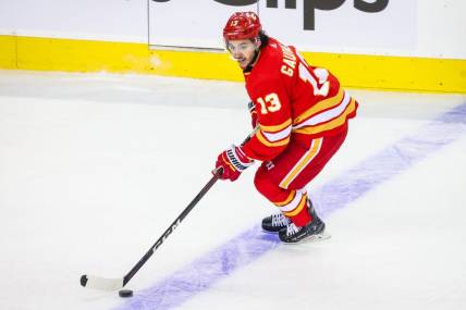 May 18, 2022; Calgary, Alberta, CAN; Calgary Flames left wing Johnny Gaudreau (13) skates with the puck against the Edmonton Oilers during the first period in game one of the second round of the 2022 Stanley Cup Playoffs at Scotiabank Saddledome. Mandatory Credit: Sergei Belski-USA TODAY Sports