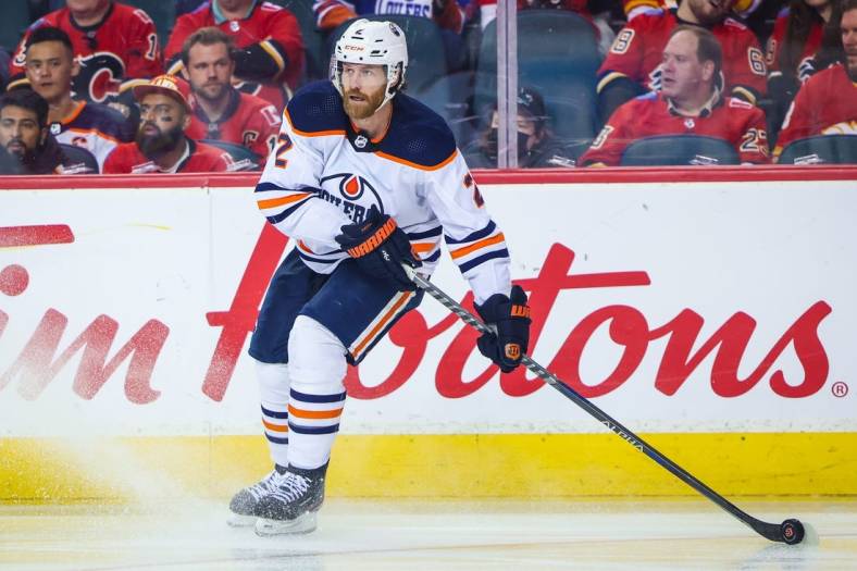 May 20, 2022; Calgary, Alberta, CAN; Edmonton Oilers defenseman Duncan Keith (2) controls the puck against the Calgary Flames during the third period in game two of the second round of the 2022 Stanley Cup Playoffs at Scotiabank Saddledome. Mandatory Credit: Sergei Belski-USA TODAY Sports