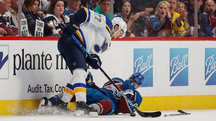 May 25, 2022; Denver, Colorado, USA; Colorado Avalanche center Nazem Kadri (91) holds his face after a play with St. Louis Blues defenseman Niko Mikkola (77) in the second period in game five of the second round of the 2022 Stanley Cup Playoffs at Ball Arena. Mandatory Credit: Isaiah J. Downing-USA TODAY Sports