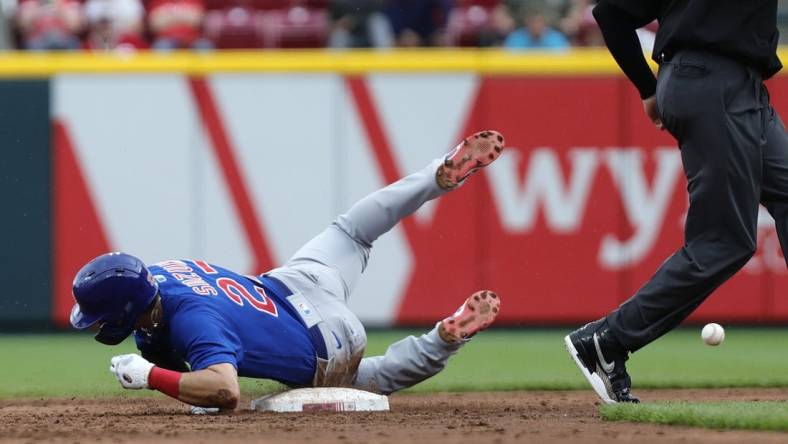 May 26, 2022; Cincinnati, Ohio, USA; Chicago Cubs right fielder Seiya Suzuki (27) slides safely after stealing second base against the Cincinnati Reds during the third inning at Great American Ball Park. Mandatory Credit: David Kohl-USA TODAY Sports