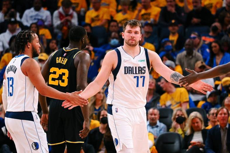 May 26, 2022; San Francisco, California, USA; Dallas Mavericks guard Luka Doncic (77) high fives guard Jalen Brunson (13) after a play against the Golden State Warriors during the second half of game five of the 2022 western conference finals at Chase Center. Mandatory Credit: Kelley L Cox-USA TODAY Sports