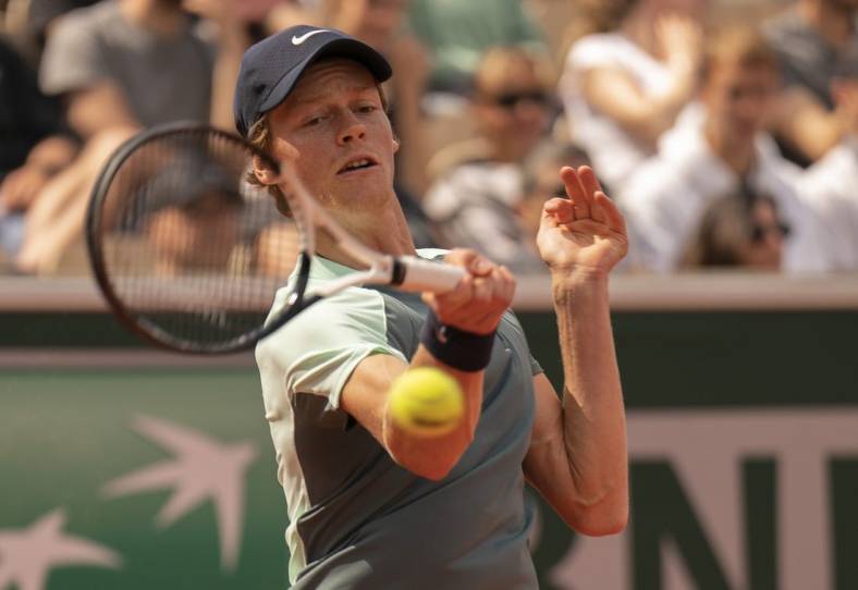 May 28, 2022; Paris, France; Jannik Sinner (ITA) returns a shot from MacKenzie McDonald (USA) during their match on day seven of the French Open at Stade Roland-Garros. Mandatory Credit: Susan Mullane-USA TODAY Sports