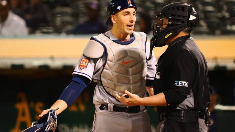 May 31, 2022; Oakland, California, USA; Houston Astros catcher Jason Castro (18) speaks to home plate umpire Manny Gonzalez after a play against the Oakland Athletics during the sixth inning at RingCentral Coliseum. Mandatory Credit: Kelley L Cox-USA TODAY Sports