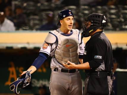 May 31, 2022; Oakland, California, USA; Houston Astros catcher Jason Castro (18) speaks to home plate umpire Manny Gonzalez after a play against the Oakland Athletics during the sixth inning at RingCentral Coliseum. Mandatory Credit: Kelley L Cox-USA TODAY Sports