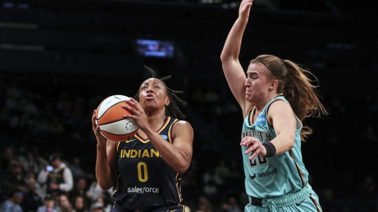 Jun 1, 2022; Brooklyn, New York, USA; Indiana Fever guard Kelsey Mitchell (0) drives past New York Liberty guard Sabrina Ionescu (20) in the first quarter at Barclays Center. Mandatory Credit: Wendell Cruz-USA TODAY Sports