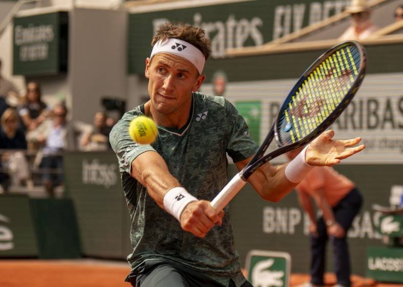 June 5, 2022; Paris, France; Casper Ruud (NOR) returns a shot during the men s singles final against Rafael Nadal (ESP) on day 15 of the French Open at Stade Roland-Garros. Mandatory Credit: Susan Mullane-USA TODAY Sports