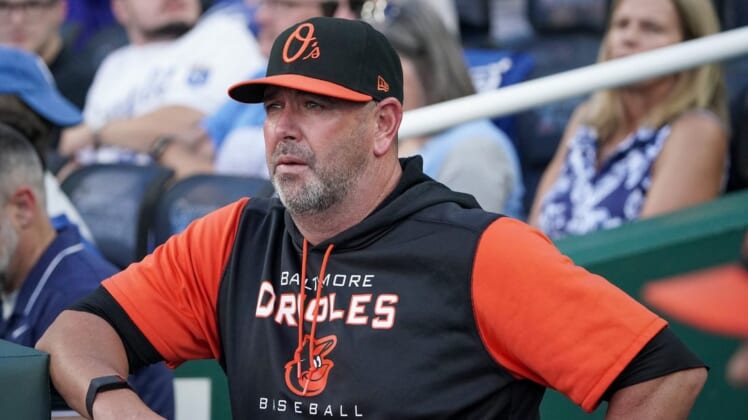 Jun 10, 2022; Kansas City, Missouri, USA; Baltimore Orioles manager Brandon Hyde (18) looks out from the dugout against the Kansas City Royals prior to the game at Kauffman Stadium. Mandatory Credit: Denny Medley-USA TODAY Sports