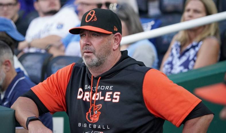 Jun 10, 2022; Kansas City, Missouri, USA; Baltimore Orioles manager Brandon Hyde (18) looks out from the dugout against the Kansas City Royals prior to the game at Kauffman Stadium. Mandatory Credit: Denny Medley-USA TODAY Sports