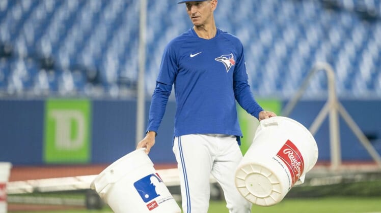 Jun 13, 2022; Toronto, Ontario, CAN; Toronto Blue Jays first base coach Mark Budzinski (53) carries two empty pails during batting practice against the Baltimore Orioles at Rogers Centre. Mandatory Credit: Nick Turchiaro-USA TODAY Sports