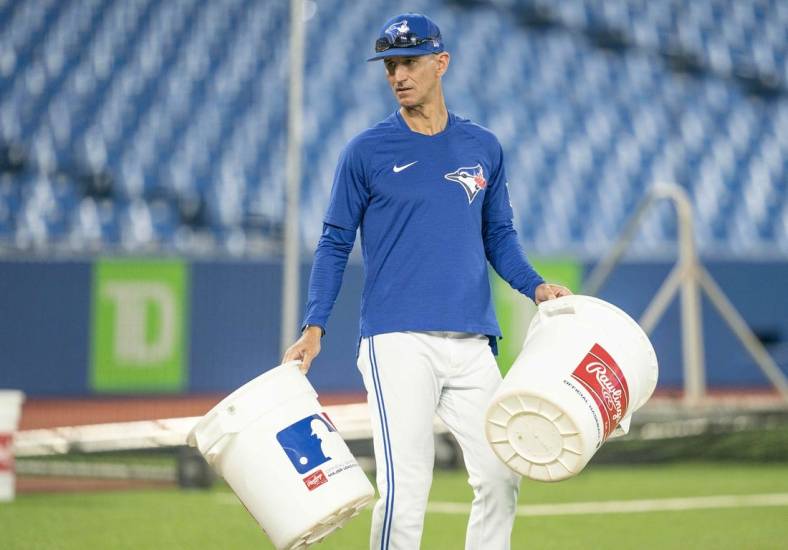 Jun 13, 2022; Toronto, Ontario, CAN; Toronto Blue Jays first base coach Mark Budzinski (53) carries two empty pails during batting practice against the Baltimore Orioles at Rogers Centre. Mandatory Credit: Nick Turchiaro-USA TODAY Sports