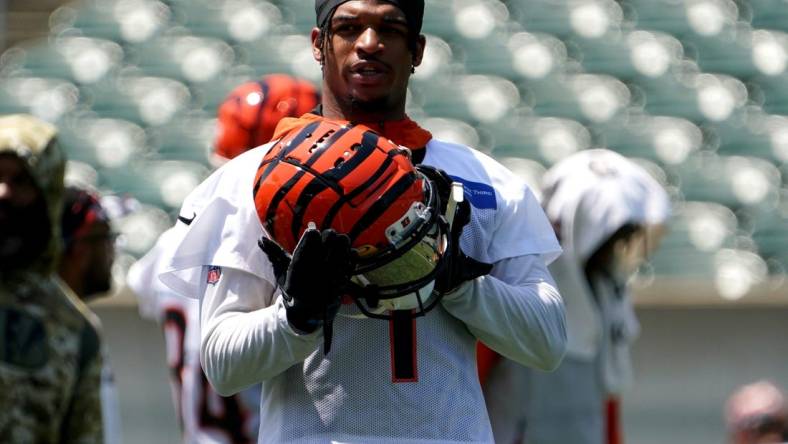 Cincinnati Bengals wide receiver Ja'Marr Chase (1) puts his helmet on between drills during organized team activities practice, Tuesday, June 14, 2022, at Paul Brown Stadium in Cincinnati.

Cincinnati Bengals Football Practice June 14 0053