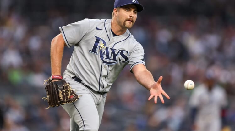 Jun 16, 2022; Bronx, New York, USA; Tampa Bay Rays starting pitcher Jalen Beeks (68) tosses the ball to first base for an out during the first inning against the New York Yankees at Yankee Stadium. Mandatory Credit: Vincent Carchietta-USA TODAY Sports