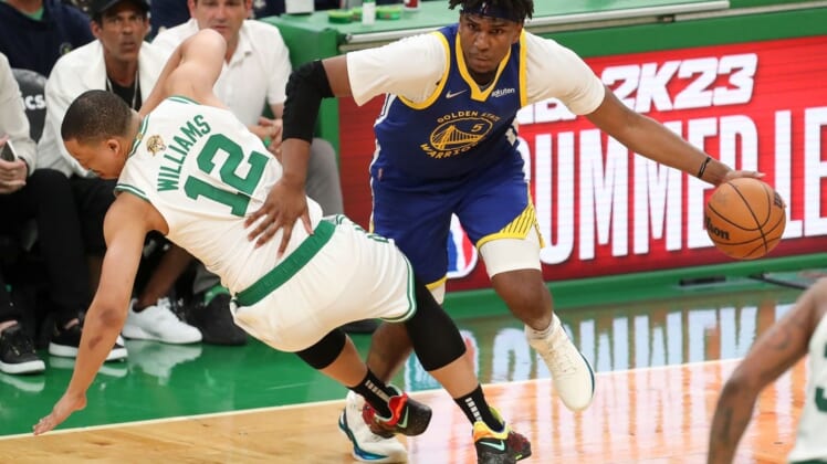 Jun 16, 2022; Boston, Massachusetts, USA; Golden State Warriors center Kevon Looney (5) drives to the basket against Boston Celtics forward Grant Williams (12) during the third quarter of game six in the 2022 NBA Finals at the TD Garden. Mandatory Credit: Paul Rutherford-USA TODAY Sports