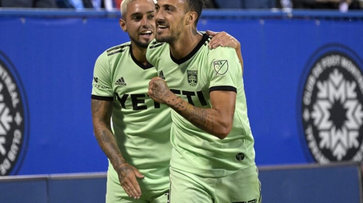 Jun 18, 2022; Montreal, Quebec, CAN; Austin FC forward Maximiliano Urruti (37) celebrates with teammate Austin FC midfielder Diego Fagundez (14) after scoring a goal against the CF Montreal during the second half at Stade Saputo. Mandatory Credit: Eric Bolte-USA TODAY Sports