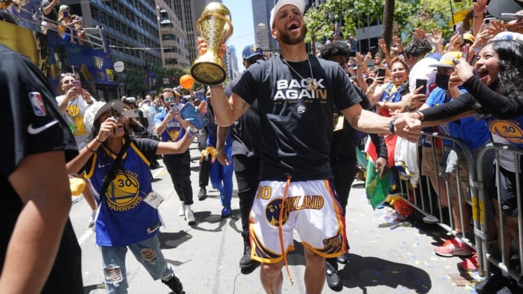 Jun 20, 2022; San Francisco, CA, USA; Golden State Warriors guard Stephen Curry interacts with fans during the Warriors championship parade in downtown San Francisco. Mandatory Credit: Cary Edmondson-USA TODAY Sports