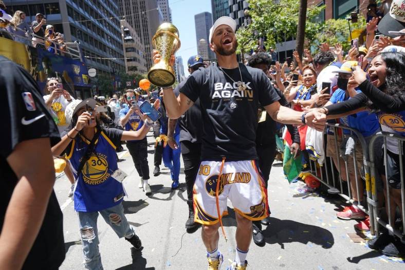 Jun 20, 2022; San Francisco, CA, USA; Golden State Warriors guard Stephen Curry interacts with fans during the Warriors championship parade in downtown San Francisco. Mandatory Credit: Cary Edmondson-USA TODAY Sports