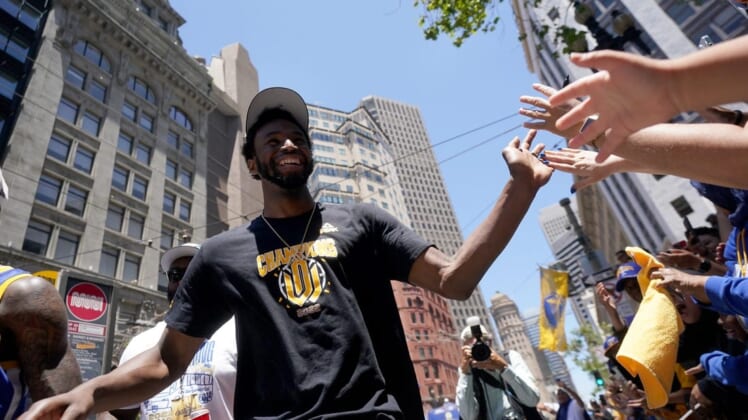 Jun 20, 2022; San Francisco, CA, USA; Golden State Warriors forward Andrew Wiggins gives high fives to fans during the Warriors championship parade in downtown San Francisco. Mandatory Credit: Cary Edmondson-USA TODAY Sports