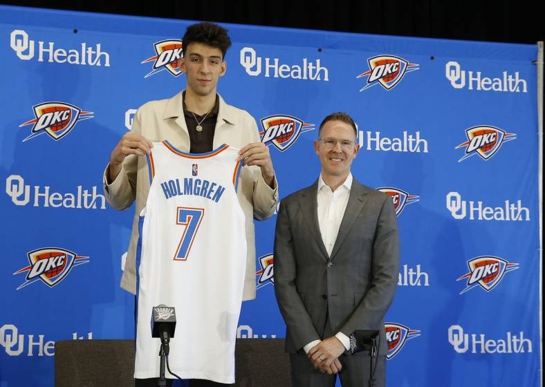 Jun 25, 2022; Oklahoma City, OK, USA; Oklahoma City Thunder forward Chet Holmgren poses with his jersey and general manager Sam Presti following an introductory press conference at Clara Luper Center. Mandatory Credit: Alonzo Adams-USA TODAY Sports